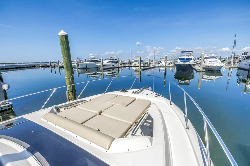Slide: The Image of Boston Whaler 405 Conquest 2023 in marina, clear blue sky, calm water reflections. - 27