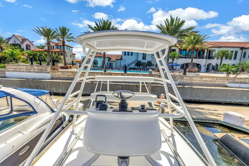 Slide: The Image of 2023 Boston Whaler 405 Conquest yacht docked near luxury waterfront homes. - 34