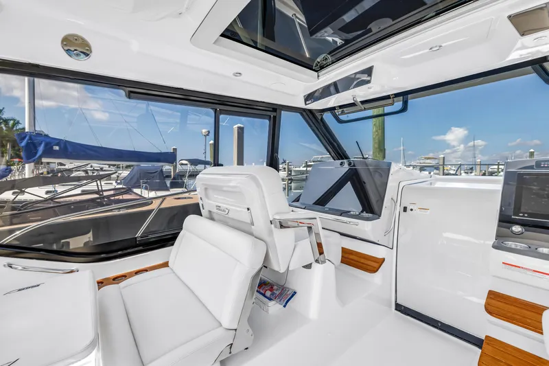 Slide: The Image of Interior of 2023 Boston Whaler 405 Conquest yacht, featuring modern helm and seating. - 37