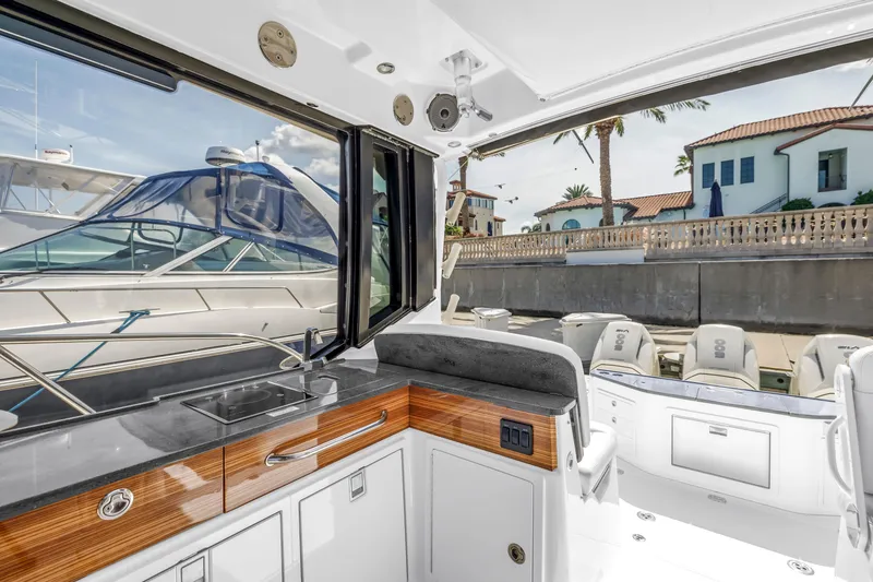 Slide: The Image of 2023 Boston Whaler 405 Conquest interior with sleek kitchen and marina view. - 42