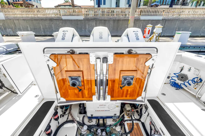 Slide: The Image of 2023 Boston Whaler 405 Conquest boat engine compartment with open hatch and visible equipment. - 45