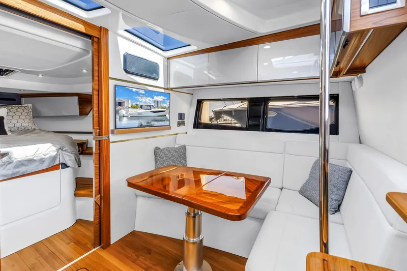 Slide: The Image of Luxurious interior of 2023 Boston Whaler 405 Conquest with elegant seating and wooden table. - 6
