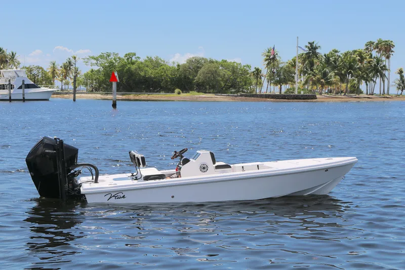 The Image of 2024 Vtech 18 boat on calm water, with tropical trees in the background. - 0