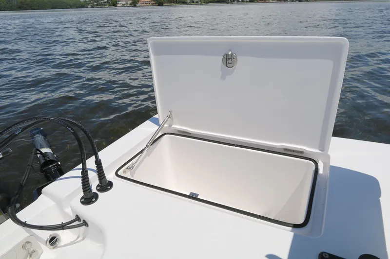 Slide: The Image of Open storage compartment on a 2024 Vtech 18 boat, near water. - 8