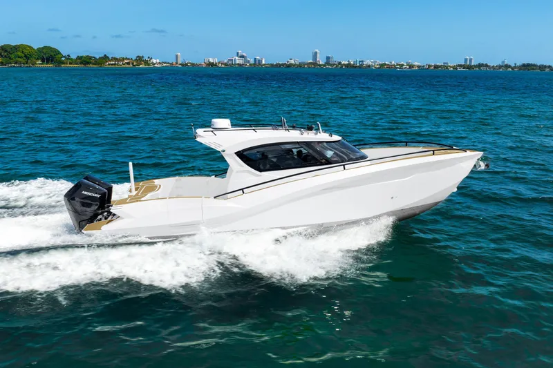 Slide: The Image of 2025 Novielli SERE boat cruising on blue ocean with city skyline in background. - 11