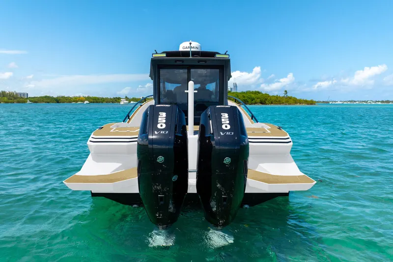 Slide: The Image of 2025 Novielli SERE boat with dual Mercury V10 engines on turquoise water. - 7