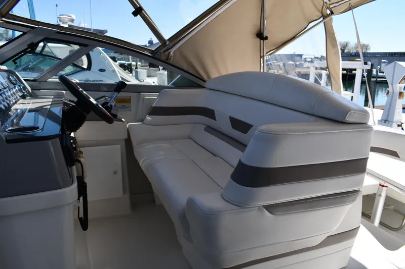 Slide: The Image of 2002 Formula 31 PC boat interior with white seating and steering wheel. - 10