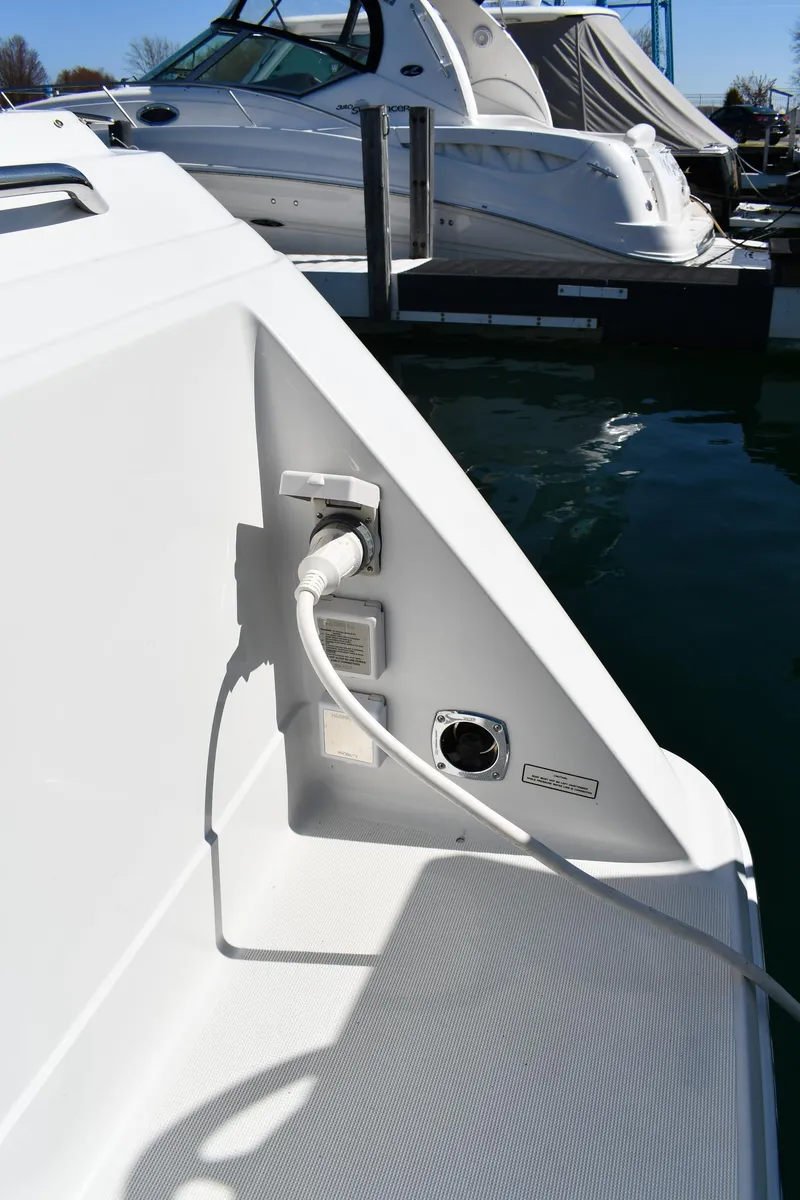 Slide: The Image of 2002 Formula 31 PC boat docked, showing power connection and sleek design. - 13