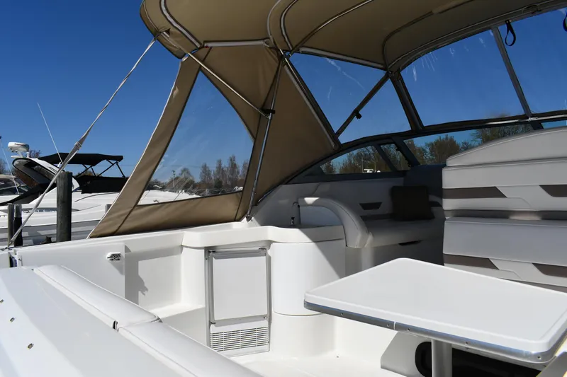 Slide: The Image of 2002 Formula 31 PC boat interior with seating and canopy under clear blue sky. - 16