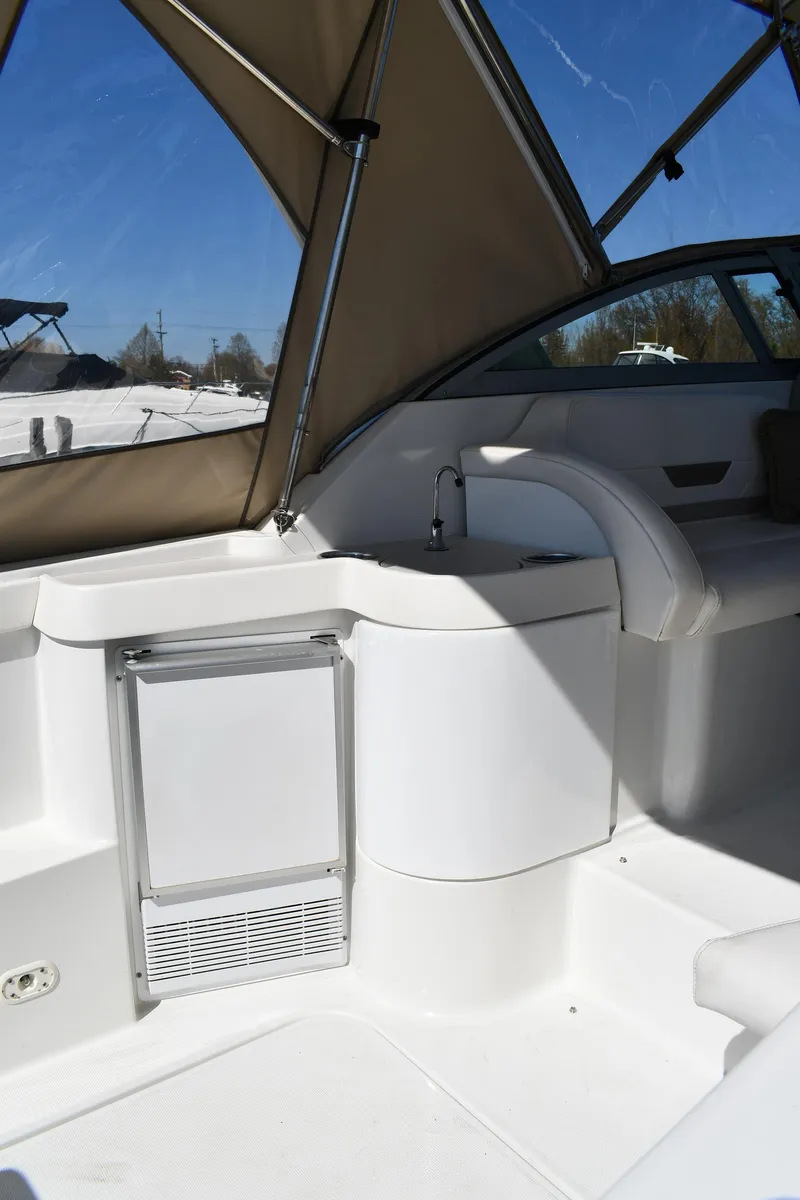 Slide: The Image of 2002 Formula 31 PC boat interior with sink and seating under canopy. - 18
