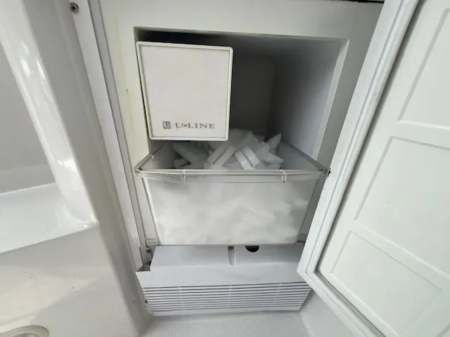 Slide: The Image of U-Line ice maker in a 2002 Formula 31 PC boat, filled with ice cubes. - 19