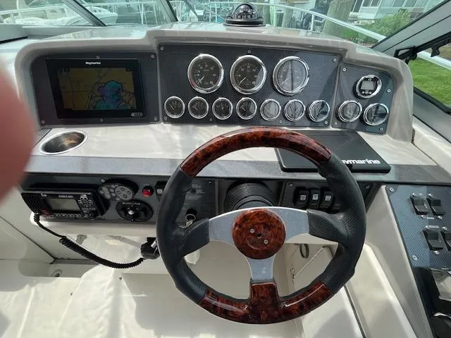 Slide: The Image of 2002 Formula 31 PC boat dashboard with gauges, GPS, and wood-accented steering wheel. - 20
