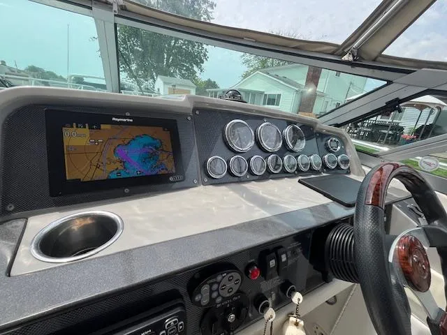 Slide: The Image of Control panel of a 2002 Formula 31 PC boat with navigation display and gauges. - 24
