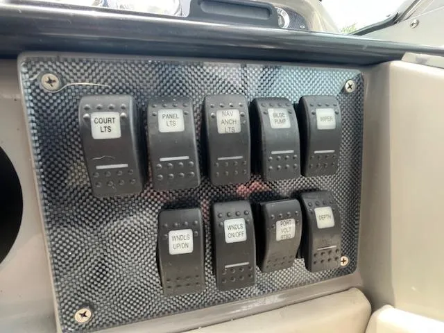 Slide: The Image of Control panel with labeled switches on a 2002 Formula 31 PC boat. - 26