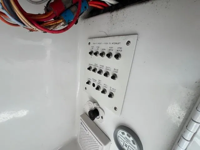 Slide: The Image of Control panel of a 2002 Formula 31 PC boat with labeled switches and wiring. - 27