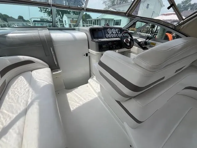 Slide: The Image of 2002 Formula 31 PC boat interior with white seating and control panel. - 28