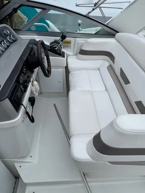 Slide: The Image of 2002 Formula 31 PC boat interior with white seating and control panel. - 34