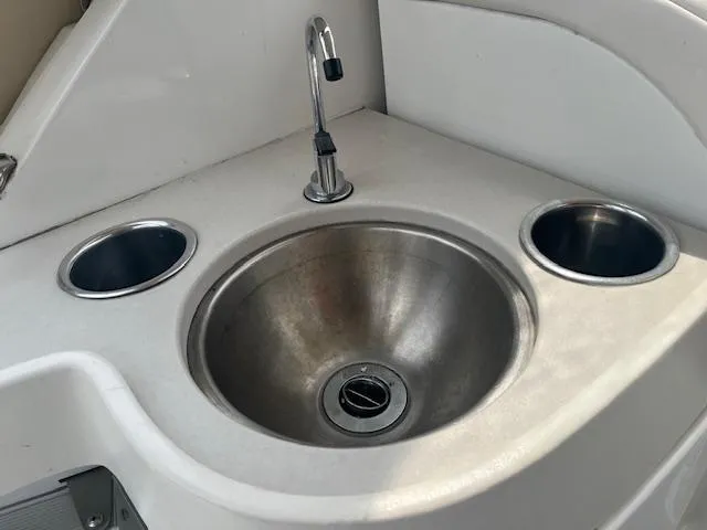 Slide: The Image of 2002 Formula 31 PC boat sink with faucet and cup holders. - 36