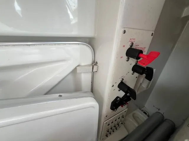 Slide: The Image of Control panel of a 2002 Formula 31 PC boat, featuring switches and levers. - 37