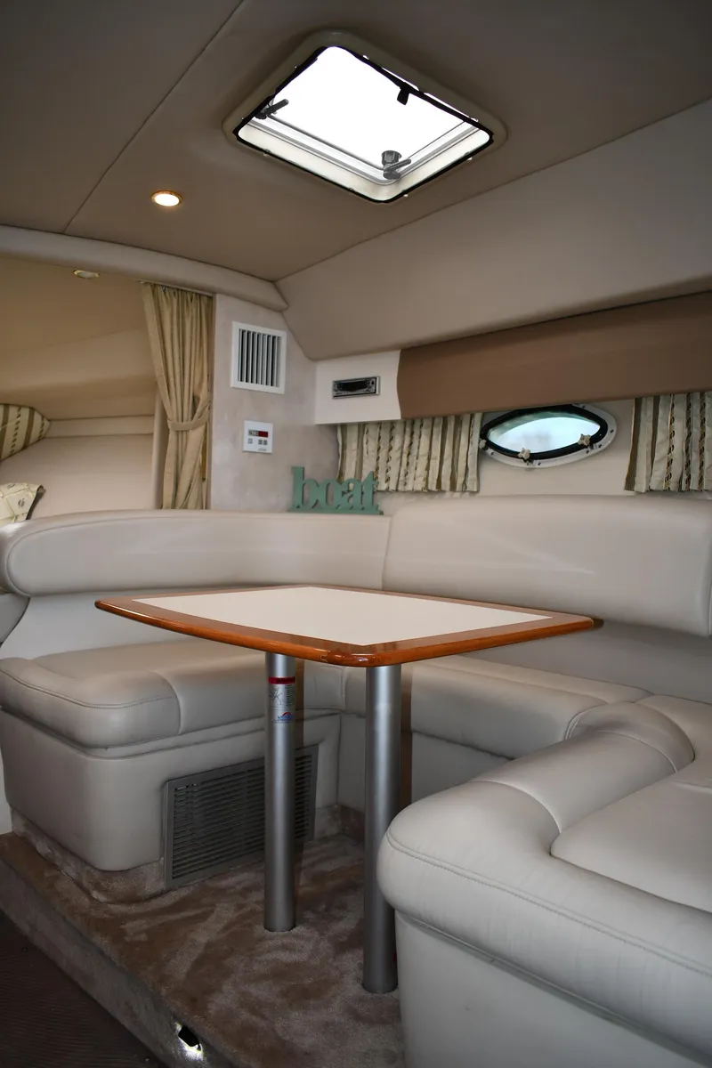 Slide: The Image of 2002 Formula 31 PC yacht interior with beige seating and wooden table. - 40