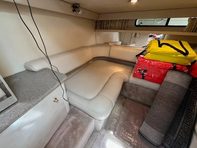 Slide: The Image of Interior of 2002 Formula 31 PC boat with beige seating and storage. - 43