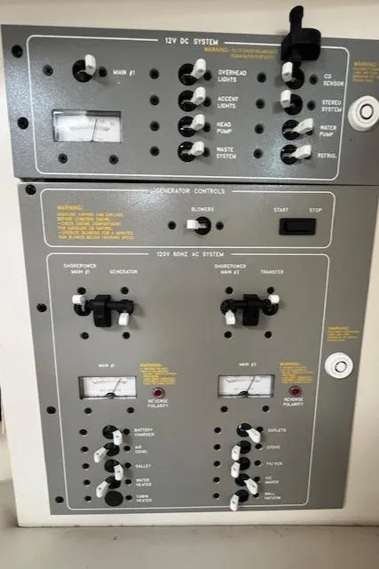 Slide: The Image of Control panel of a 2002 Formula 31 PC boat, featuring various system switches and gauges. - 45