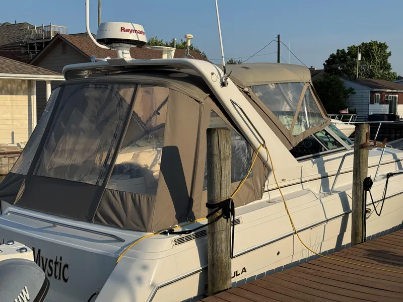 Slide: The Image of 2002 Formula 31 PC boat docked, featuring tan canopy and Raymarine radar. - 5