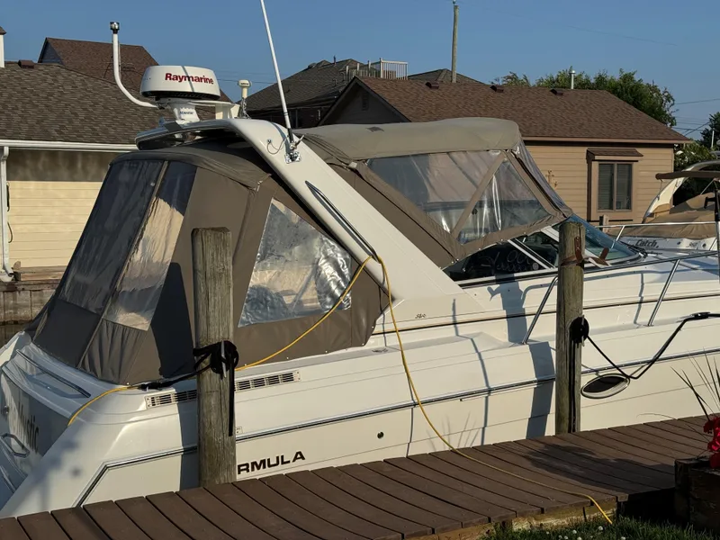 Slide: The Image of 2002 Formula 31 PC boat docked with canopy and Raymarine radar. - 6