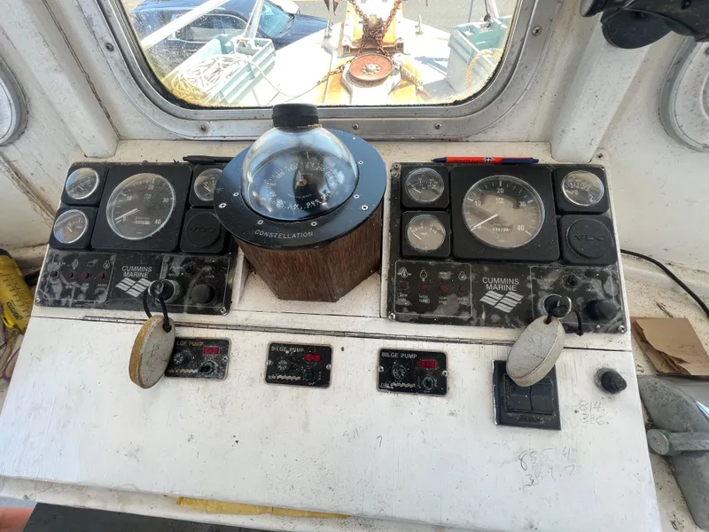 Slide: The Image of Control panel of a 1984 JC 35 boat with gauges and compass. - 11