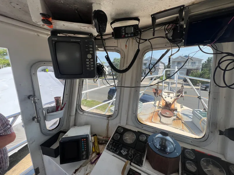 Slide: The Image of 1984 JC 35 boat cockpit with navigation equipment and marine radar. - 12