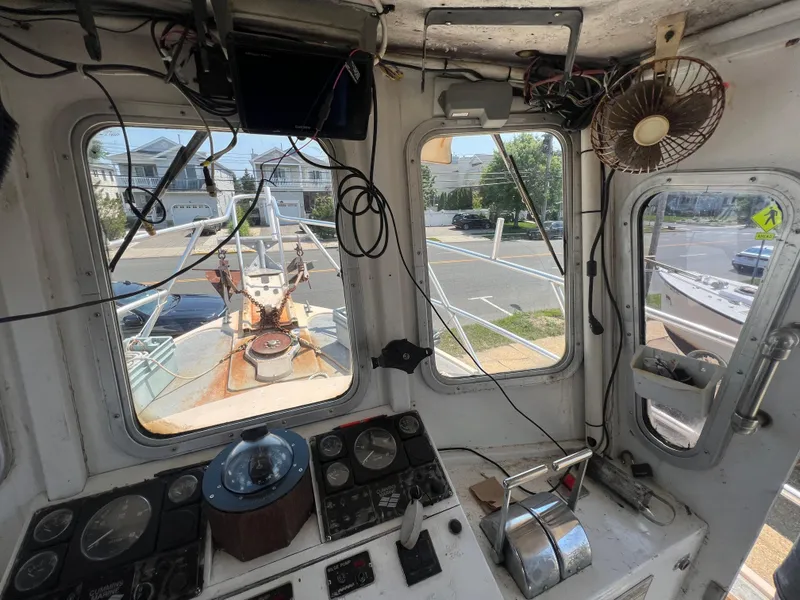 Slide: The Image of Interior of a 1984 JC 35 boat cockpit with controls and windows. - 13