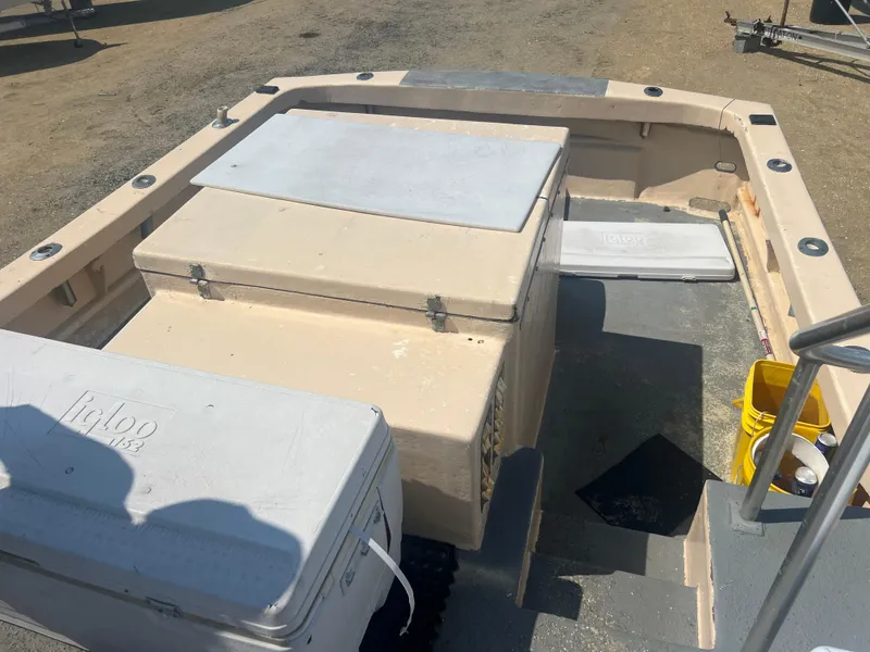 Slide: The Image of 1984 JC 35 boat deck with storage compartments and coolers. - 18