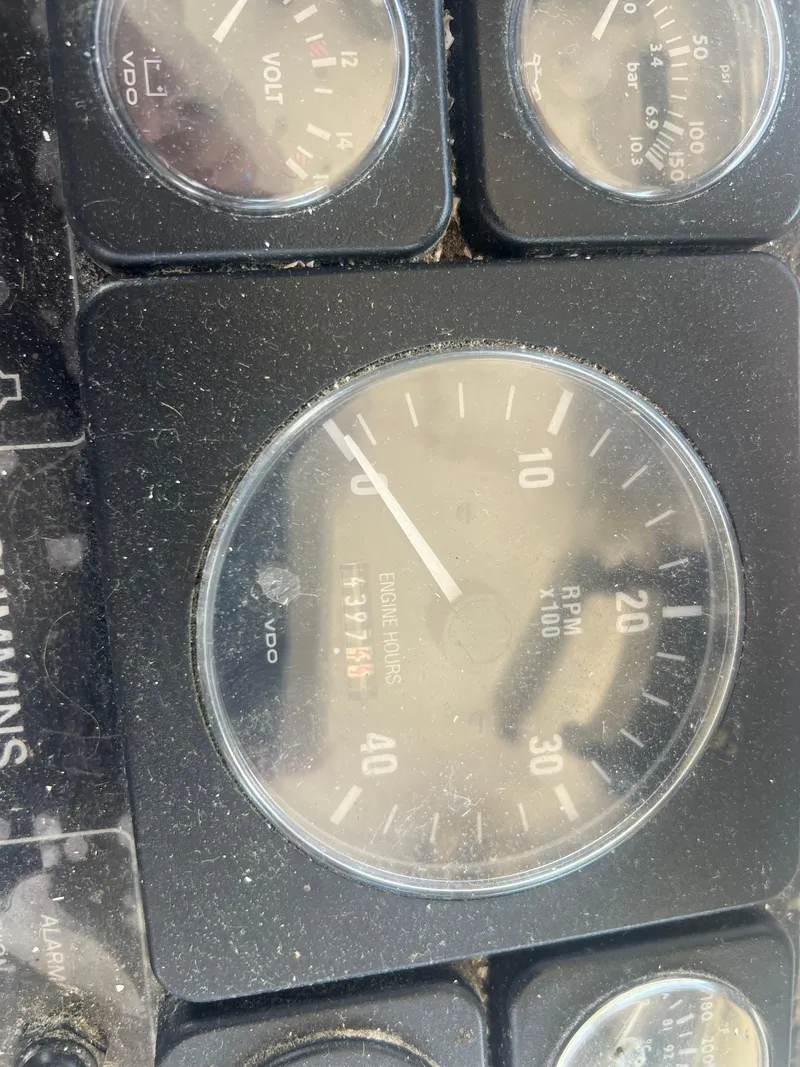 Slide: The Image of Dashboard gauges of a 1984 JC 35, showing RPM and engine hours. - 19