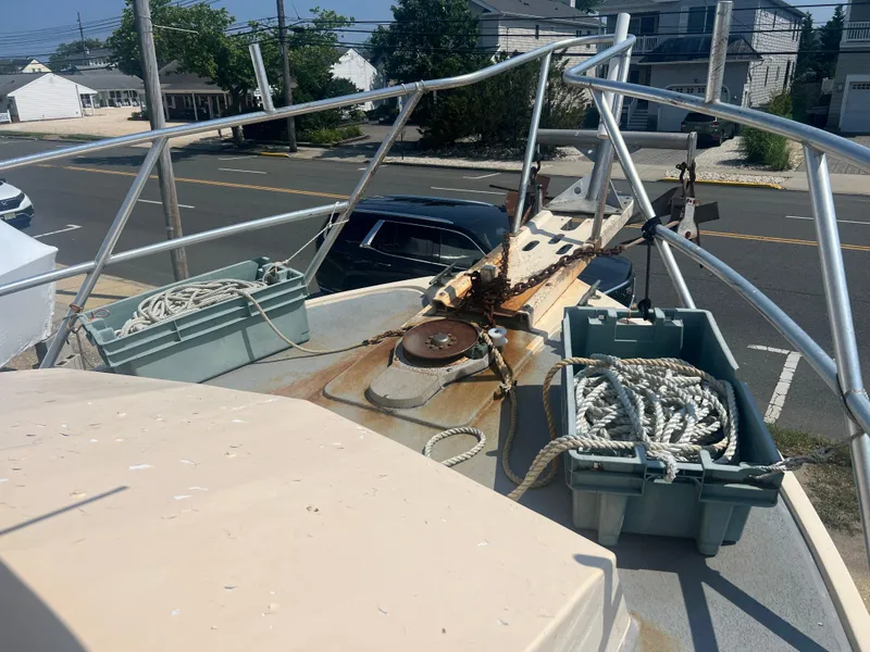 Slide: The Image of Bow of a 1984 JC 35 boat with ropes and metal railings. - 6