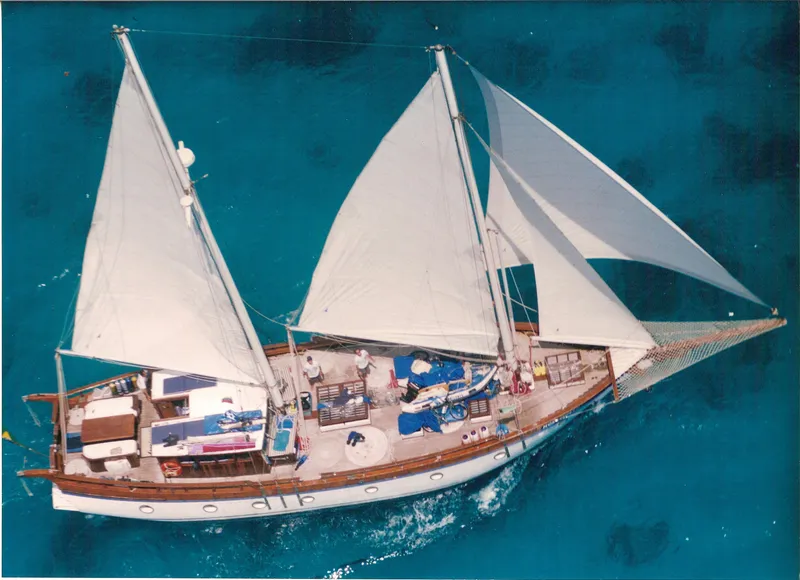 The Image of Aerial view of 1991 Custom Horacio Carabelli Schooner sailing on clear blue water. - 0