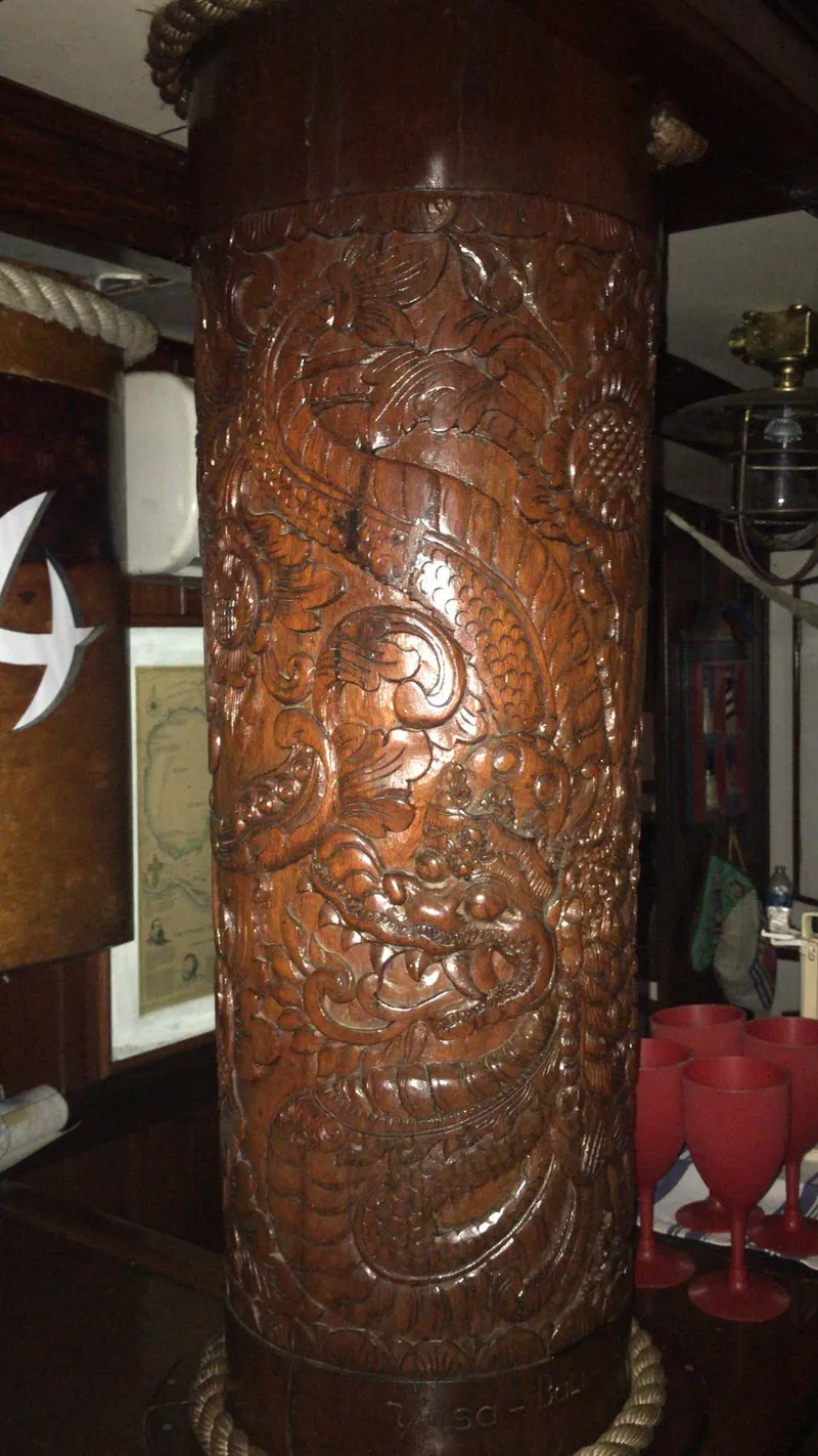 Slide: The Image of Intricately carved wooden pillar on 1991 Horacio Carabelli Schooner, featuring detailed nautical designs. - 16