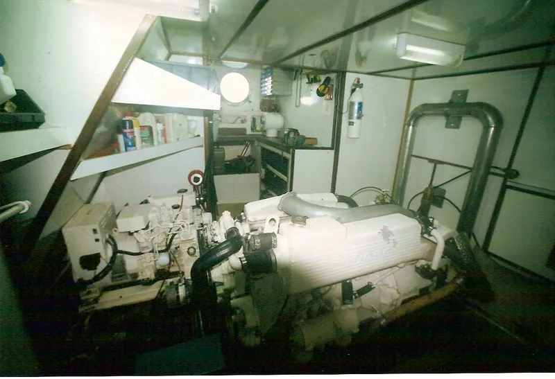 Slide: The Image of Engine room of 1991 Custom Horacio Carabelli Schooner, featuring machinery and storage shelves. - 17