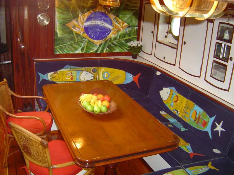 Slide: The Image of Cozy dining area on 1991 Horacio Carabelli Schooner with nautical-themed decor and fruit centerpiece. - 19