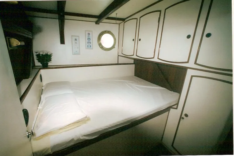 Slide: The Image of Cozy cabin interior of 1991 Horacio Carabelli Schooner with bed and storage cabinets. - 23