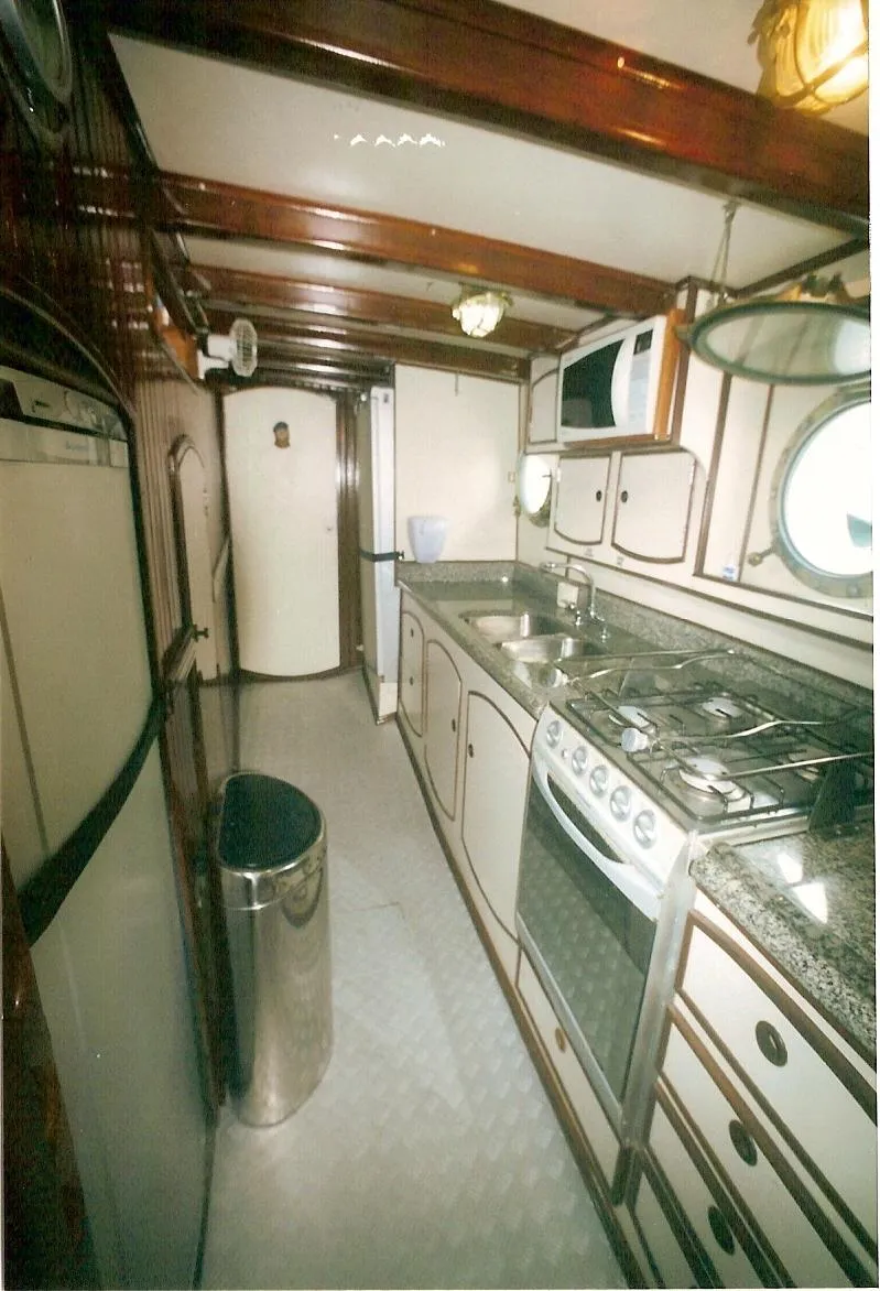 Slide: The Image of Interior of 1991 Custom Horacio Carabelli Schooner kitchen with stove, sink, and microwave. - 28