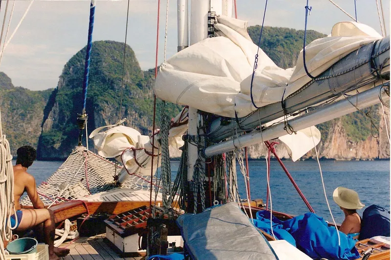 Slide: The Image of Sailing on a 1991 Custom Horacio Carabelli Schooner near rocky cliffs, with passengers enjoying the view. - 29