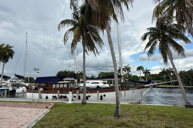 Slide: The Image of Schooner "Horacio Carabelli" docked by palm trees, cloudy sky, 1991 model. - 31