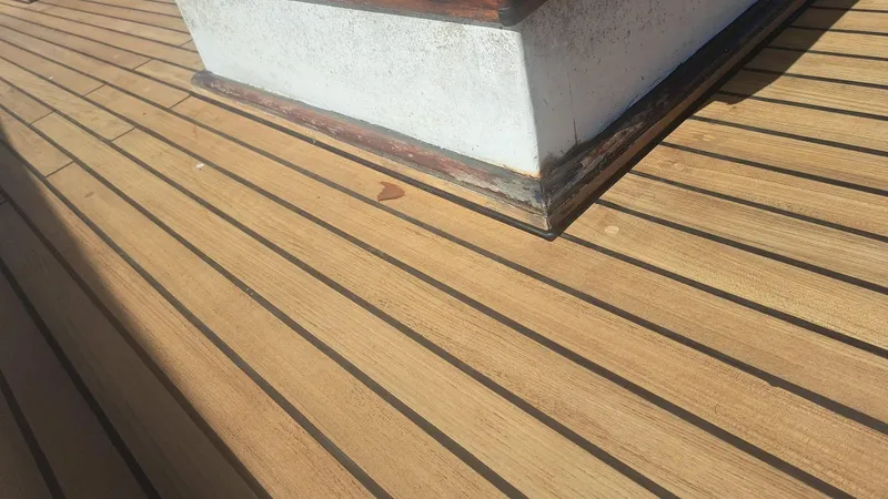 Slide: The Image of Teak deck of 1991 Custom Horacio Carabelli Schooner, showcasing wood grain and craftsmanship. - 37