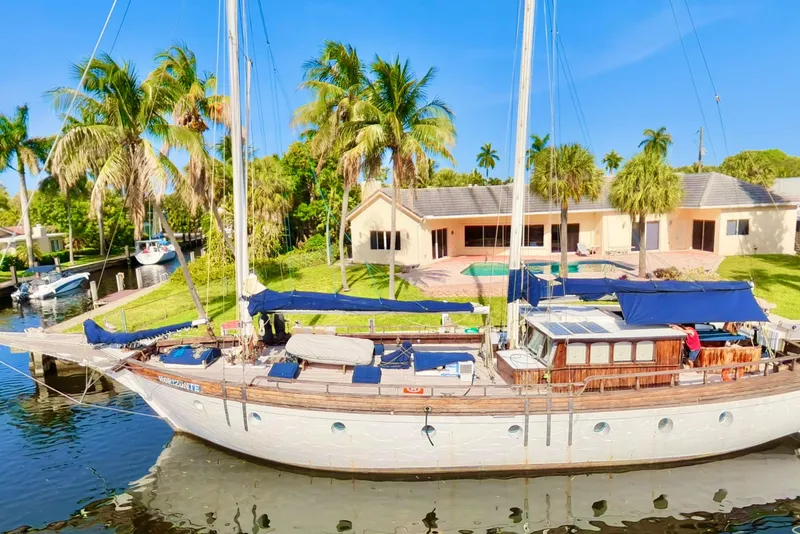 The Image of Custom 1991 Horacio Carabelli Schooner docked by a tropical waterfront home. - 0