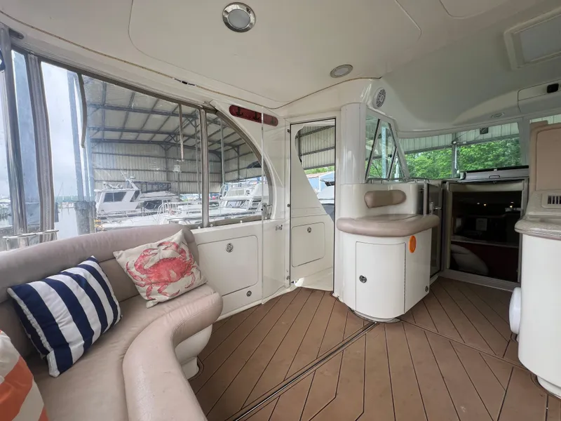 Slide: The Image of Interior of 2004 Sea Ray 480 Motor Yacht with plush seating and nautical-themed pillows. - 10