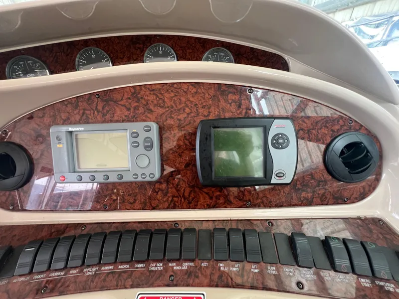 Slide: The Image of Dashboard of 2004 Sea Ray 480 Motor Yacht with navigation instruments and controls. - 16