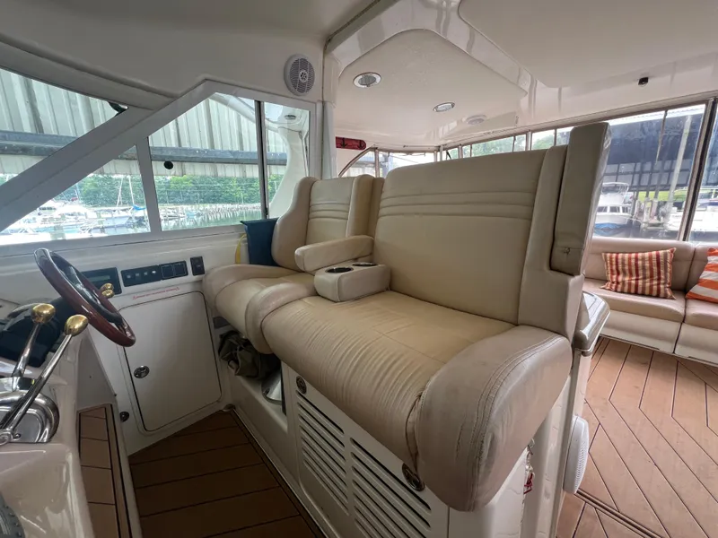 Slide: The Image of Interior of 2004 Sea Ray 480 Motor Yacht with beige seating and wooden accents. - 19