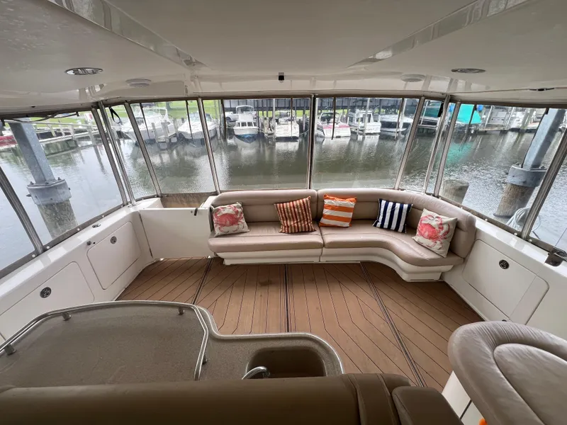 Slide: The Image of Luxurious 2004 Sea Ray 480 Motor Yacht interior with plush seating and scenic marina view. - 20