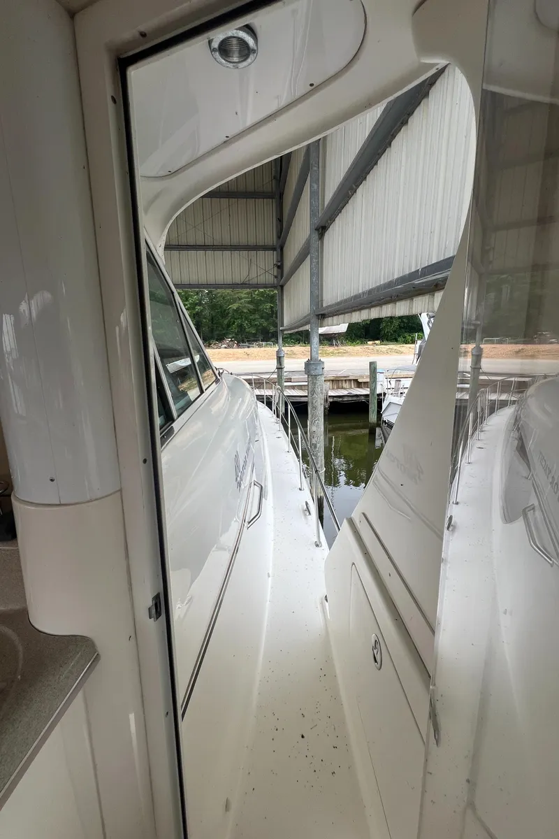 Slide: The Image of 2004 Sea Ray 480 Motor Yacht docked in a covered marina, side view. - 21