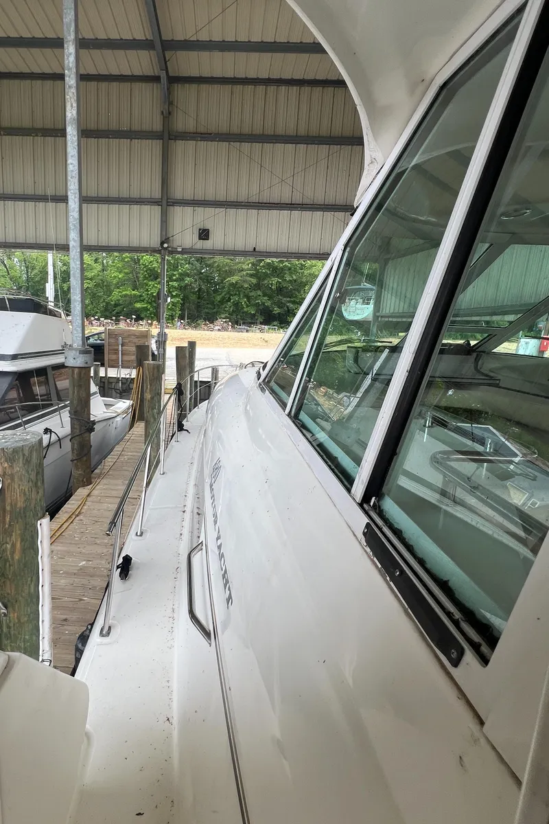 Slide: The Image of 2004 Sea Ray 480 Motor Yacht docked under a covered marina. - 22